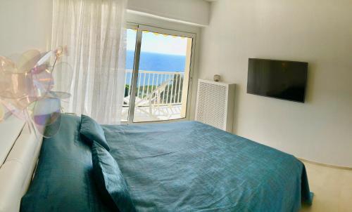 a bedroom with a bed and a large window at Monte Carlo View in Cap d'Ail