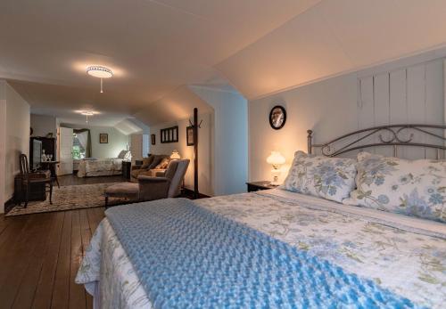 a bedroom with a large bed and a living room at Riverboat Bed & Breakfast in Natchez