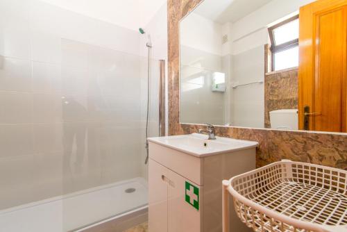 Un baño con lavabo y ducha en Cabanas Ria Sea View By Algartur, en Cabanas de Tavira