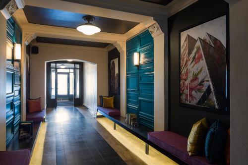 a hallway with blue doors and benches in a building at City Suites Hotel in Chicago