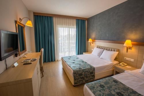 Ένα ή περισσότερα κρεβάτια σε δωμάτιο στο Side Aquamarin Resort & Spa