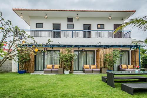 a view of a house with a green yard at Lavini Hoian Boutique Villa in Hoi An