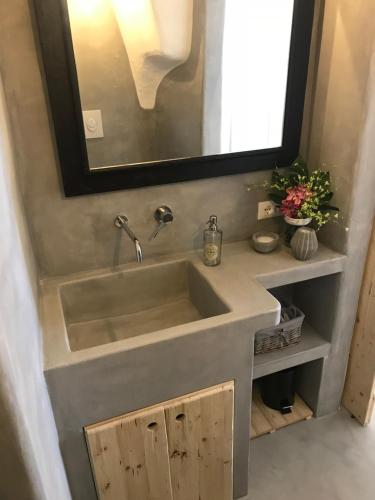 a bathroom with a sink and a mirror at CASA FLAMI' in Ostuni