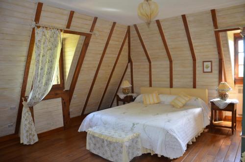 a bedroom with a bed and wooden walls at La Gueriniere in Cénac-et-Saint-Julien
