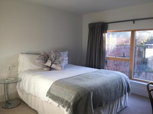um quarto com uma cama e uma grande janela em Jorvik Lodge em York