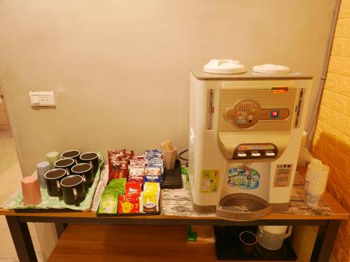 a small refrigerator and a microwave on a table at Kinmen Backpacker in Jincheng