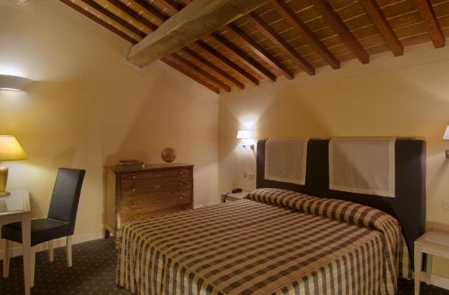 เตียงในห้องที่ Hotel Arnolfo & Aqua Laetitia Spa & Beauty