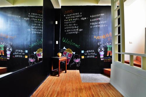 a restaurant with a black wall with a chalkboard at 博愛泊旅讀心境 in Hualien City