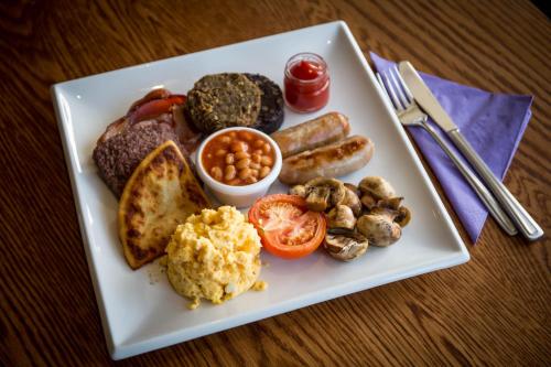 a plate of food with different types of breakfast foods at Parklands Hotel & Country Club in Newton Mearns