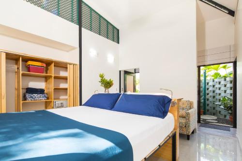 um quarto com uma cama grande e almofadas azuis em Yaba Chigui Lodge em Ojochal
