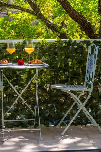 a table with a plate of food and two glasses of wine at Villa Adria in Cavtat
