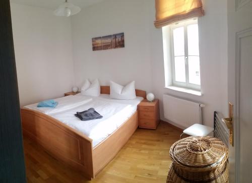 1 dormitorio con 1 cama con sábanas blancas y ventana en Villa Bellevue Ferienwohnung 6, en Ahlbeck