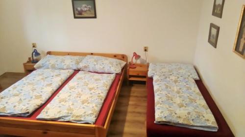 two twin beds in a room with at Penzión Aqua in Liptovský Mikuláš