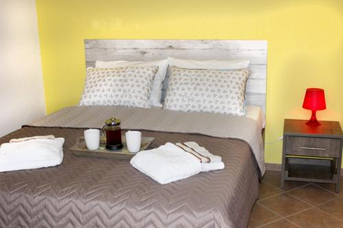 a bedroom with a bed with two towels on it at Souzana Rooms in Nea Plagia