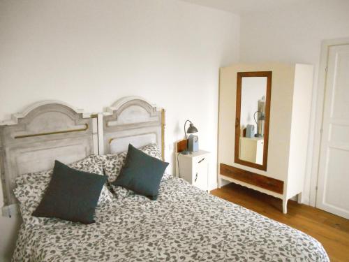 a bedroom with a bed with two pillows and a mirror at Una finestra sul lago..Appartamento Verbania in Verbania