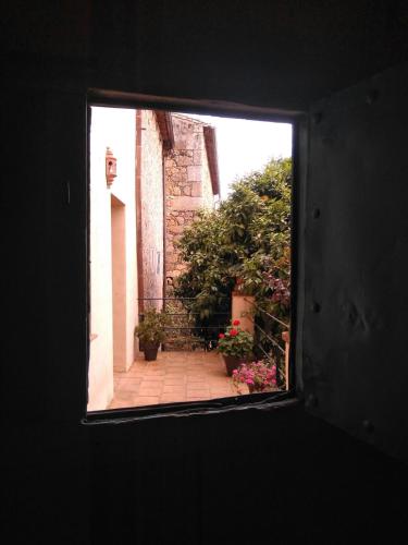 a view from a window of a courtyard with flowers at Casa Rural Donatila in Villasbuenas de Gata