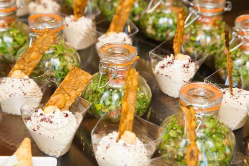 a bunch of miniature food items in glass jars at P Quattro Relax Hotel in Wadi Musa