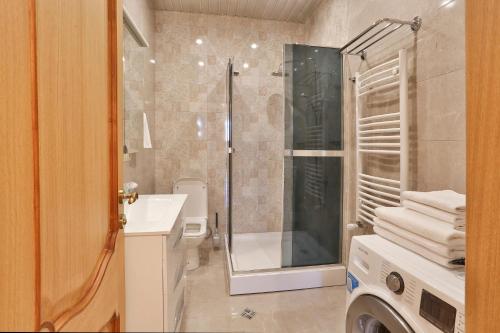 a bathroom with a shower and a toilet and a sink at Serviced Apartment on Rustaveli Avenue in Tbilisi City