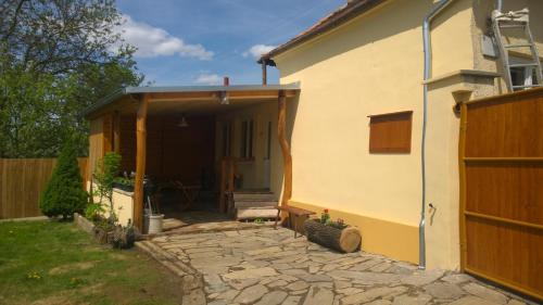 a house with a stone walkway in front of it at Chalupa u kostela in Lukov