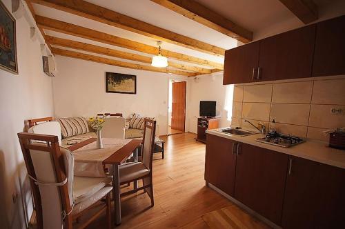 a kitchen and a dining room with a table in a room at Apartments Imperial in Dubrovnik