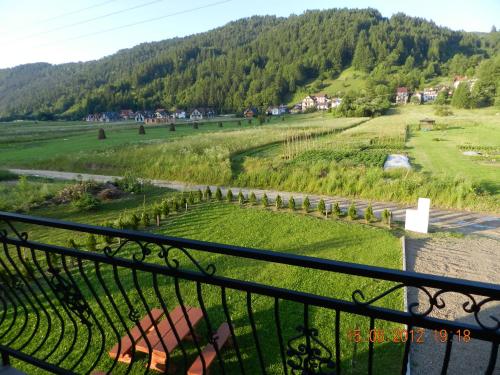 a view of a green field from a balcony at Zielone Zacisze in Krościenko