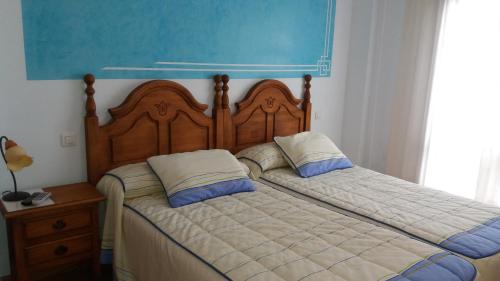 a bedroom with two beds with pillows on them at Hotel Brezales in Espejón