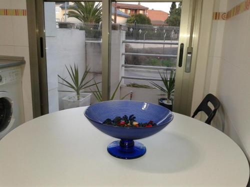 a blue bowl sitting on top of a table at La casona de flores in Fuensalida