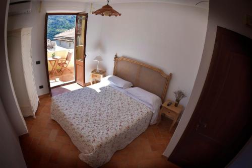 a bedroom with a bed and a door to a patio at Il Giardino di Julia B&B in Tortora