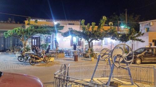 a city street at night with a bench and tables at Venetian Cistern Villa in Kalamítsion Alexándrou