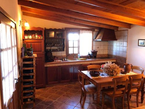 a kitchen with a wooden table and a dining room at El Pajero de Erese in Erese