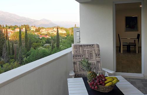 a basket of fruit on a table on a balcony at Apartments Močići in Močići