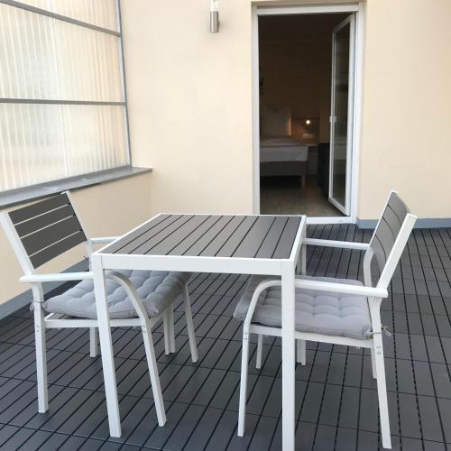 a table and two chairs on a patio at Hotel Select Suites & Aparts in Mönchengladbach