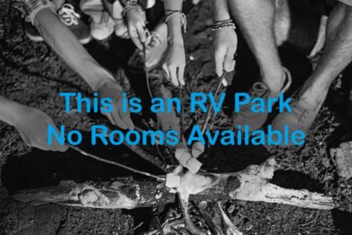 a group of people standing around a camp fire at RV Park at Lakeside Casino in Pahrump