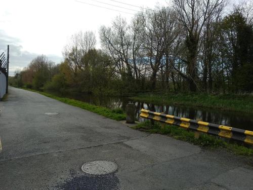 a yellow and black rail next to a river at Townhouse 4 Barrow Lane in Carlow