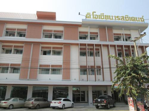 a building with cars parked in front of it at The Ocean Residence in Nakhon Ratchasima