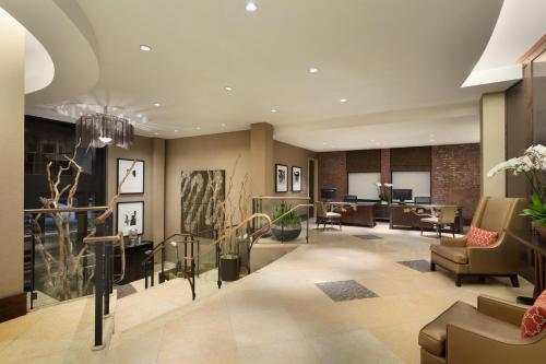 a lobby with a waiting area with chairs and tables at The Fairmont Heritage Place Ghirardelli Square in San Francisco