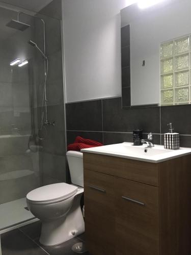 a bathroom with a toilet and a sink and a shower at Sonder in Caleta De Fuste