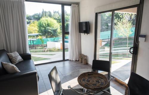 a living room with a couch and a glass table at Terralagum in Villa Parque Siquiman