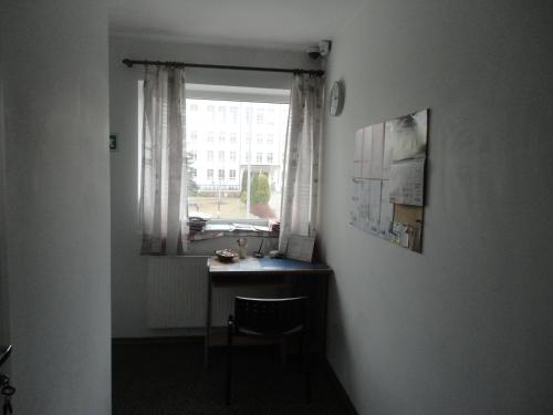 a desk in a room with a window and a chair at Anette House in Pärnu