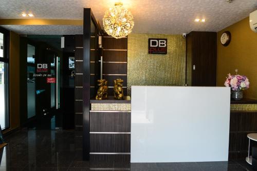 a lobby with a dmg sign on the wall at DB Plus 3 in Bangkok