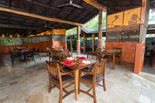 a dining room with wooden tables and chairs at Sunrise Club Hotel in Negril