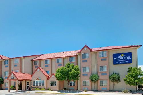 a hotel with a sign on the front of it at Microtel Inn & Suites by Wyndham Albuquerque West in Albuquerque