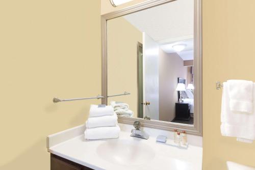 a bathroom with a sink and a mirror at Hawthorn Extended Stay by Wyndham Dayton in Dayton