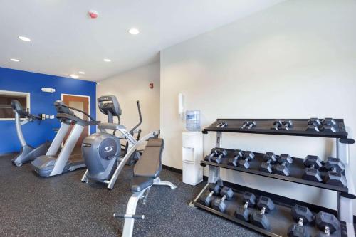 a gym with treadmills and exercise bikes in a room at Microtel Inn & Suites by Wyndham Georgetown Delaware Beaches in Georgetown
