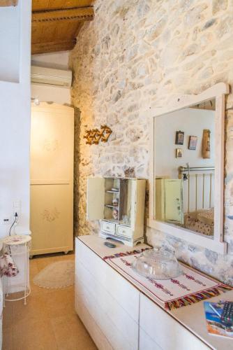 a kitchen with a mirror on top of a counter at Private studio in historic house in Lástros