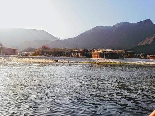 a body of water with mountains in the background at Yasmina Beach in Taba