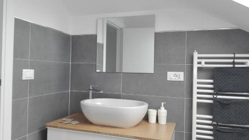 a bathroom with a white sink and a mirror at Tivoli ShortLets - Catania in San Gregorio di Catania