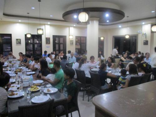 a group of people sitting at tables in a restaurant at WMV Hotel & Restaurant in Infanta