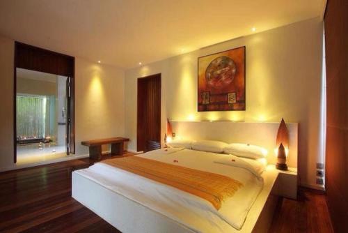 a bedroom with a large bed in a room at Villa Tiara in Senggigi 