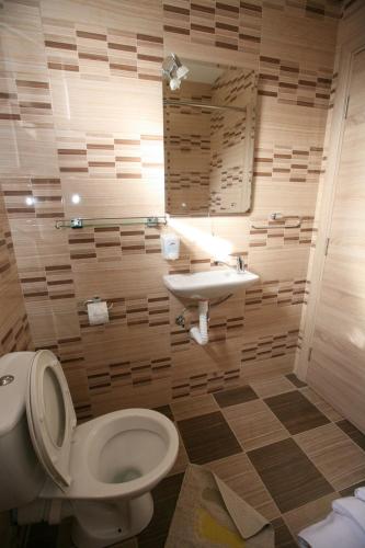 a bathroom with a toilet and a sink at Ruža Apartments Sea View in Kotor